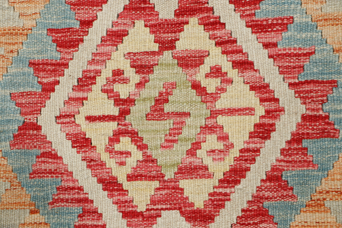 Afghan Kilim rug by eastofhere with geometric patterns in earthy tones, measuring 108x76cm, displayed on a neutral floor.