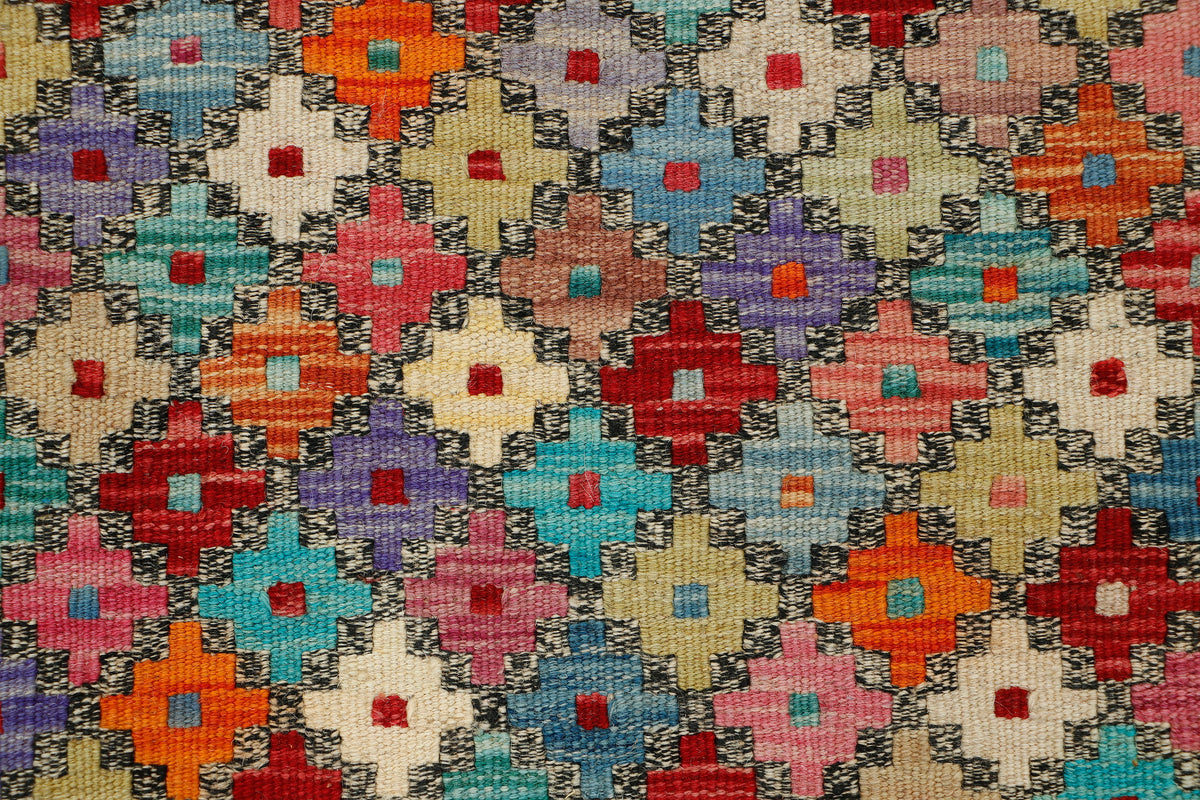 Afghan Kilim runner rug by eastofhere, 240x80cm, featuring traditional geometric patterns in vibrant colors, laid out on a wooden floor.