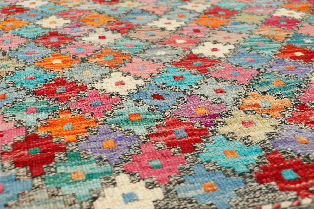 Afghan Kilim runner rug by eastofhere, 240x80cm, featuring traditional geometric patterns and vibrant colors on woven fabric.