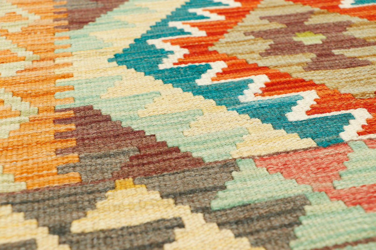 Afghan Kilim runner rug by eastofhere, 200x60cm, featuring traditional geometric patterns and vibrant colors on woven fabric.