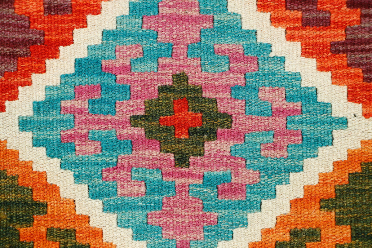Afghan Kilim runner rug by eastofhere, 190cm x 57cm, with traditional geometric patterns and vibrant colors, laid on wooden floor.
