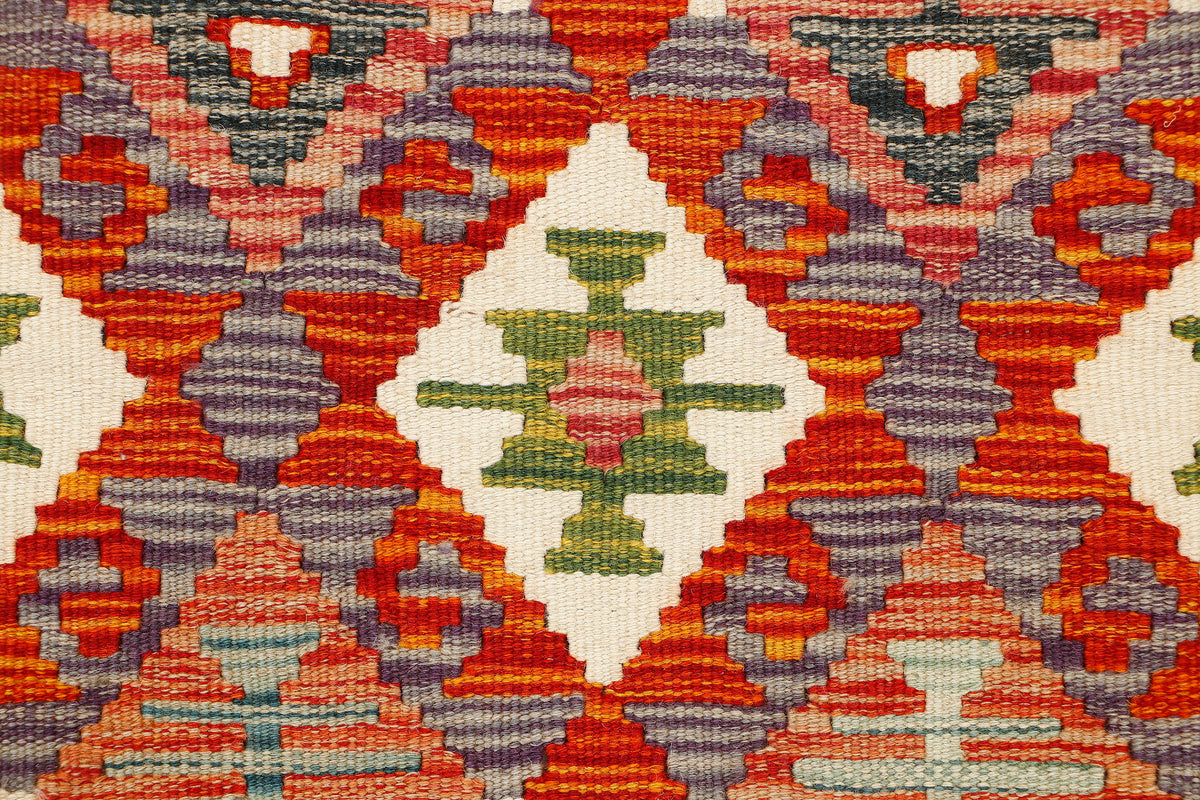 Afghan Kilim runner rug by eastofhere, 146x62cm, featuring traditional geometric patterns and vibrant earthy tones.