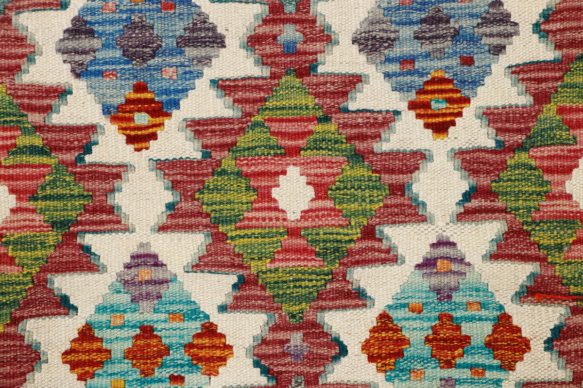 Afghan Kilim runner rug by eastofhere with intricate geometric patterns in vibrant colors, measuring 148 x 62 cm.