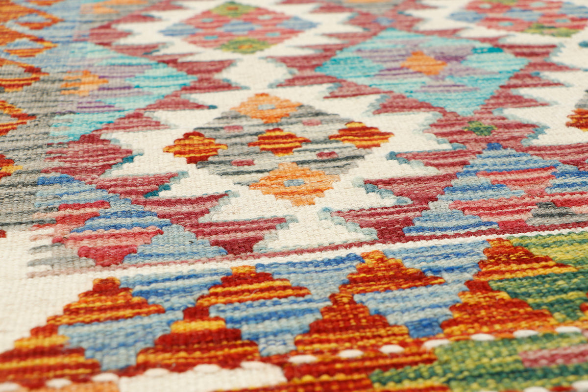 Afghan Kilim runner rug by eastofhere, 148 x 62cm, featuring traditional geometric patterns in vibrant colors.