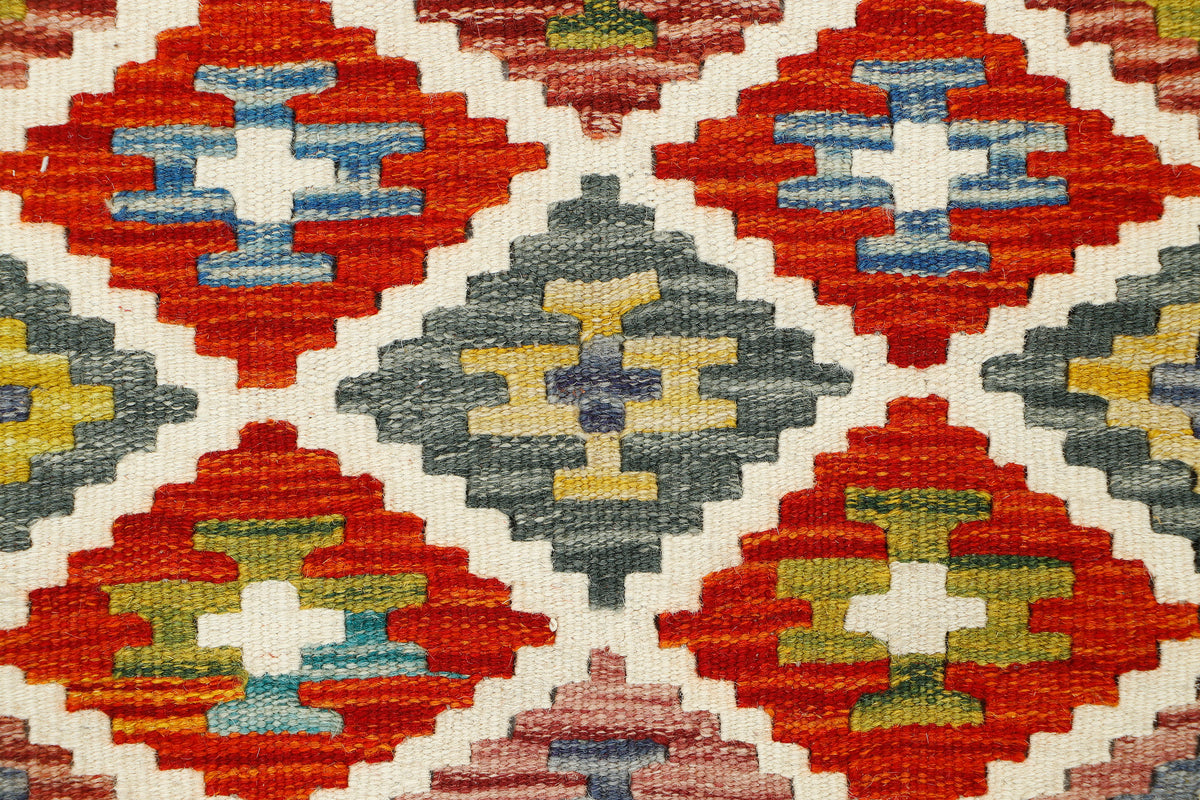 Afghan Kilim runner rug by eastofhere, 149x61cm, featuring traditional geometric patterns and vibrant colors on woven fabric.