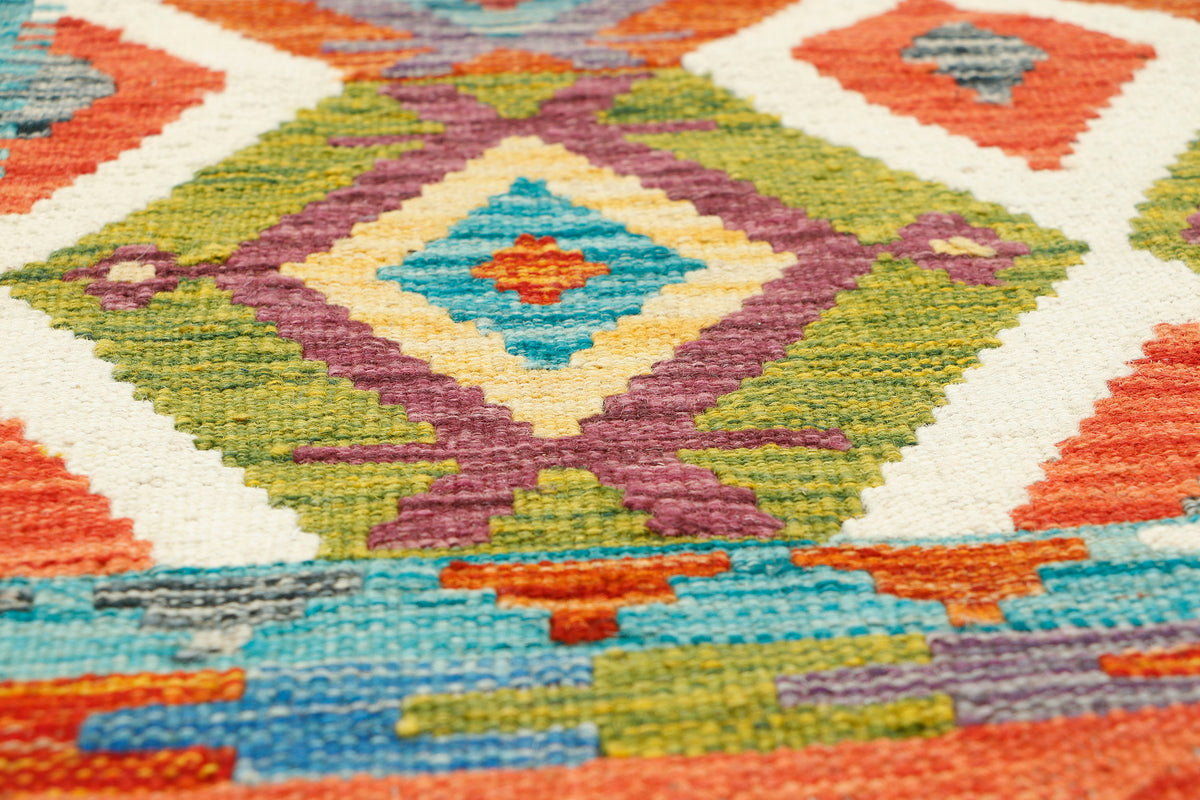 Afghan Kilim runner rug by eastofhere, 148x62cm, featuring traditional geometric patterns in vibrant colors.