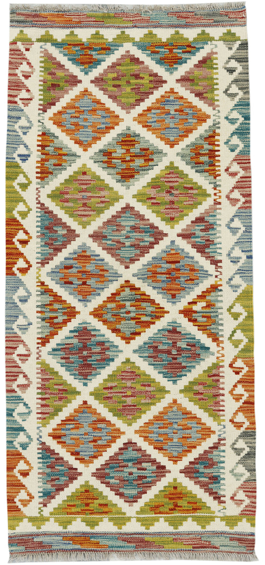 Afghan Kilim runner rug by eastofhere, featuring traditional geometric patterns in vibrant colors, measuring 145x64cm.