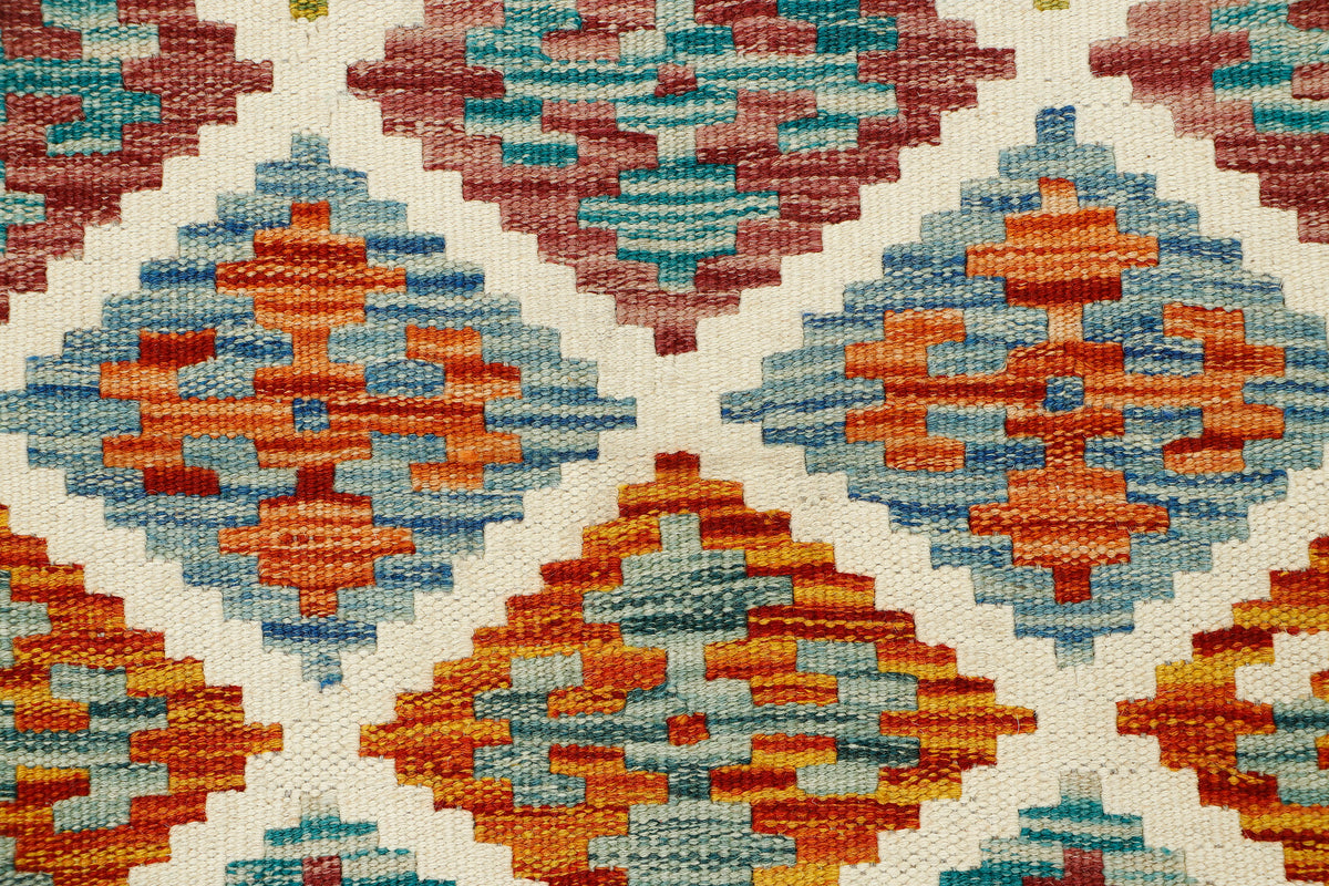 Afghan Kilim runner rug by eastofhere, 145x64cm, featuring traditional geometric patterns and vibrant colors on woven fabric.
