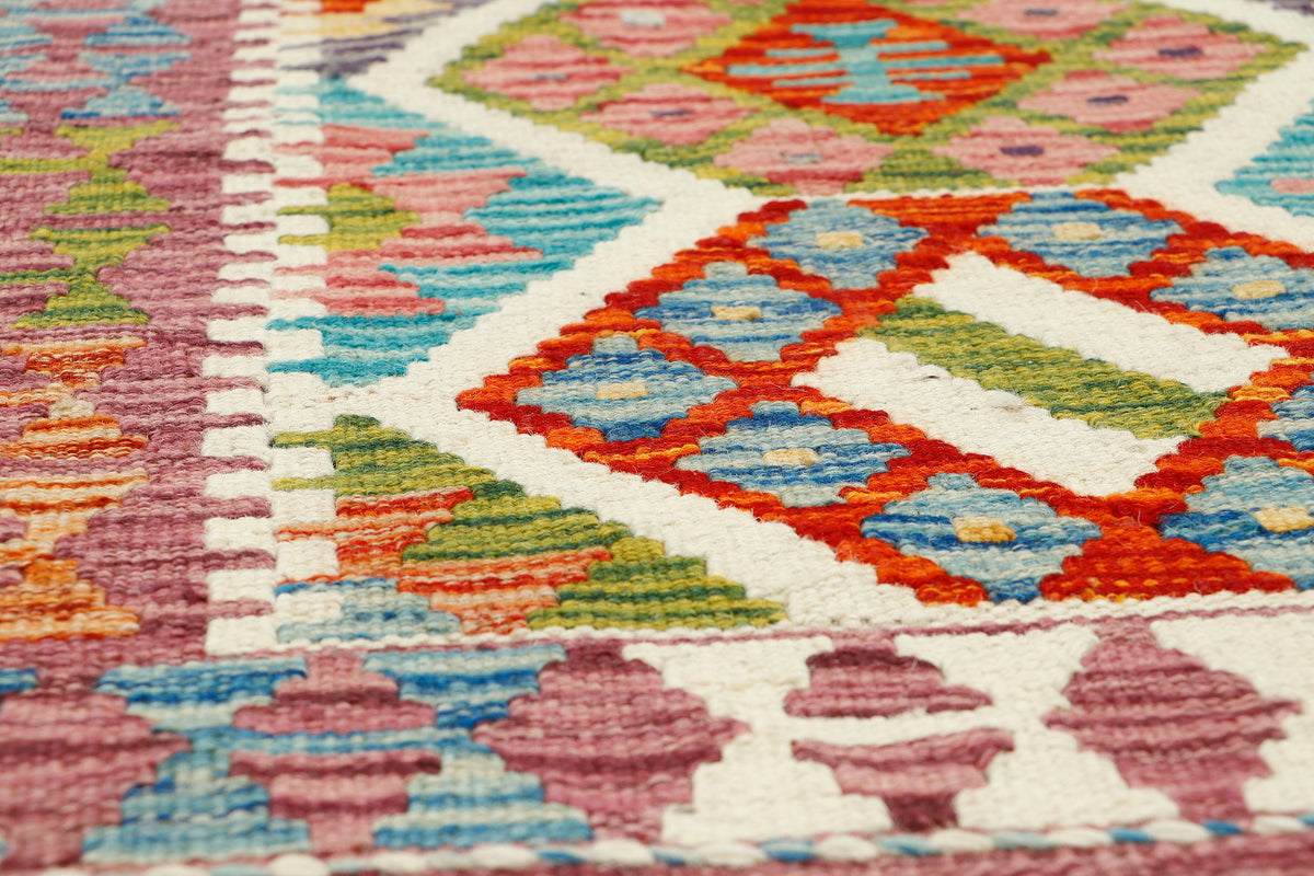 Afghan Kilim runner rug by eastofhere, 145x62cm, featuring traditional geometric patterns and vibrant colors.