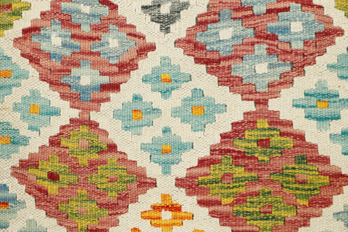 Afghan Kilim runner rug by eastofhere, 145cm long and 57cm wide, featuring traditional geometric patterns and vibrant colors.