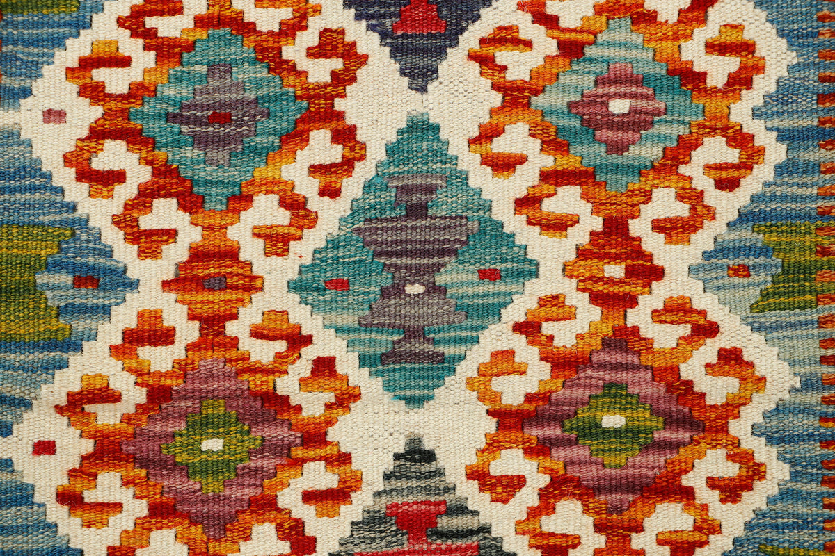 Afghan Kilim runner rug by eastofhere, 146x62cm, showcasing intricate geometric patterns and vibrant colors on woven fabric.