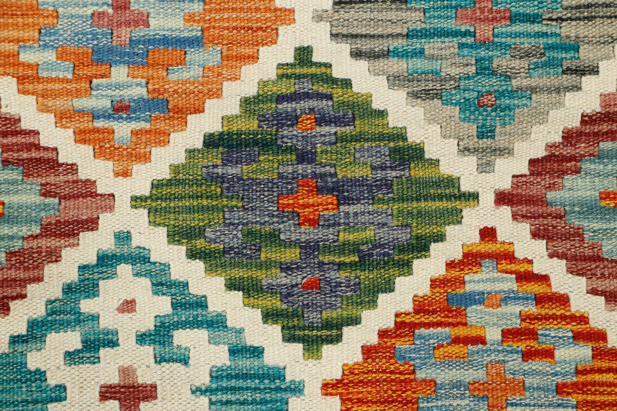 Afghan Kilim runner rug by eastofhere, 142x60cm, featuring traditional geometric patterns and vibrant colors on a woven surface.