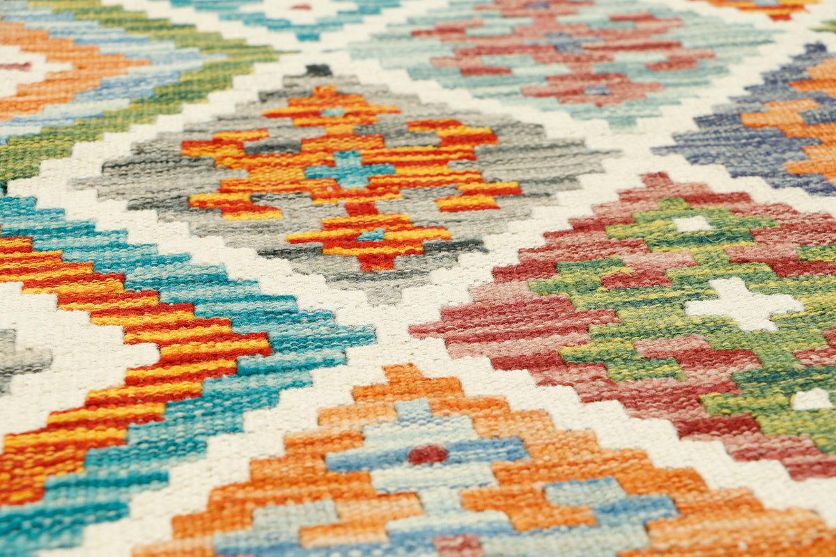 Afghan Kilim runner rug by eastofhere, 142x60cm, with colorful geometric patterns on a woven textile.