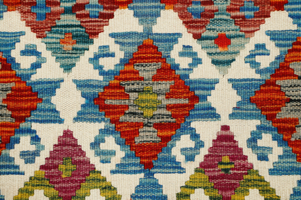 Afghan Kilim runner rug by eastofhere, 150cm long and 63cm wide, featuring traditional geometric patterns in vibrant colors.