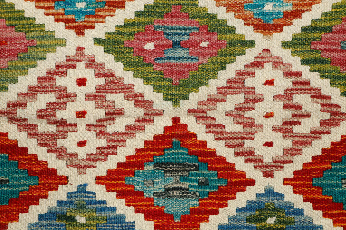 Afghan Kilim runner rug by eastofhere, 144x63cm with traditional geometric patterns in vibrant colors.