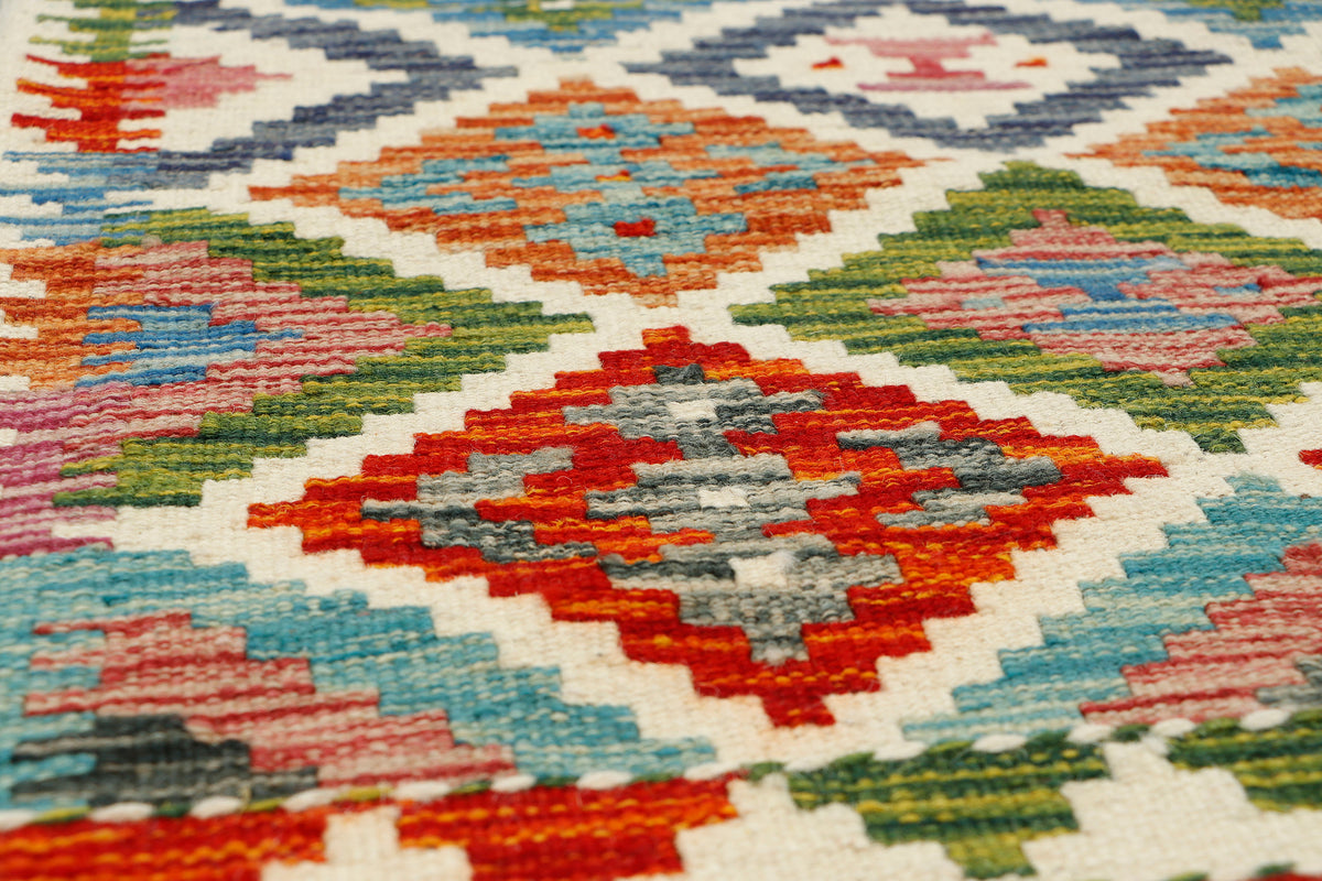 Afghan Kilim runner rug by eastofhere, 144x63cm with colorful geometric patterns on woven textile.