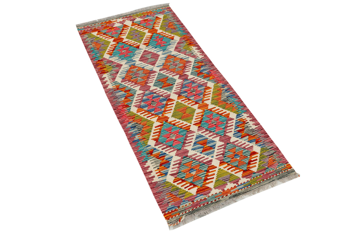 Afghan Kilim runner rug by eastofhere displaying intricate geometric patterns in vibrant colors, measuring 142x64cm.