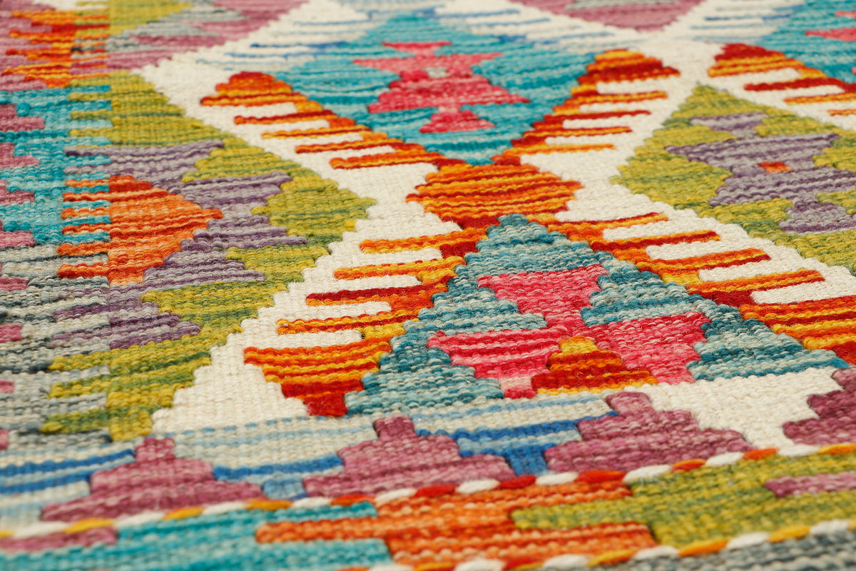 Afghan Kilim runner rug by eastofhere, 142x64cm, featuring traditional geometric patterns and vibrant colors on a woven textile.
