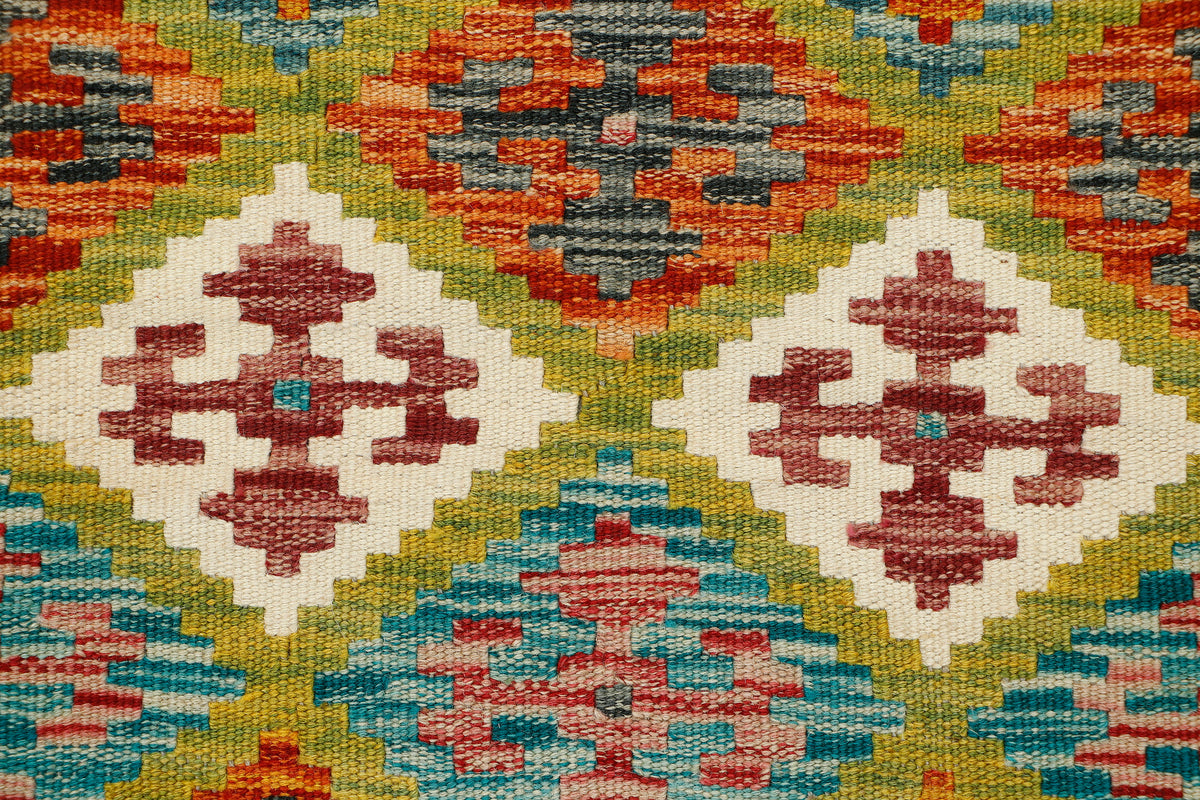 Afghan Kilim runner rug by eastofhere, 149x65cm, featuring traditional geometric patterns and vibrant colors on a woven textile.