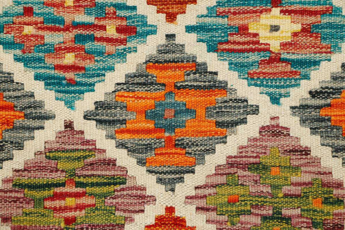 Afghan Kilim runner rug by eastofhere, 152x62cm, featuring traditional geometric patterns and vibrant colors on a woven surface.