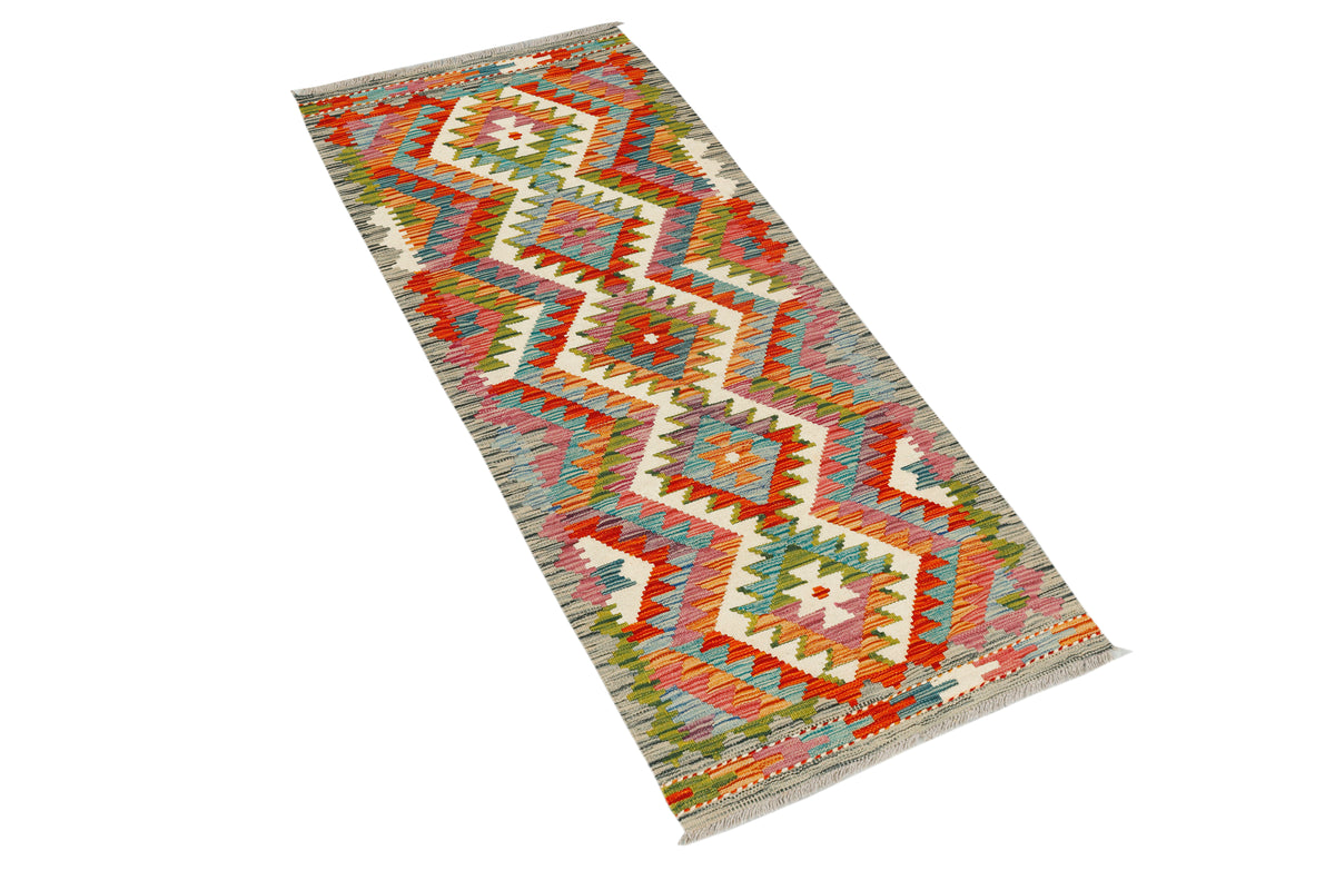 Afghan Kilim runner rug by eastofhere, 152x61cm, featuring traditional geometric patterns and vibrant colors on woven fabric.