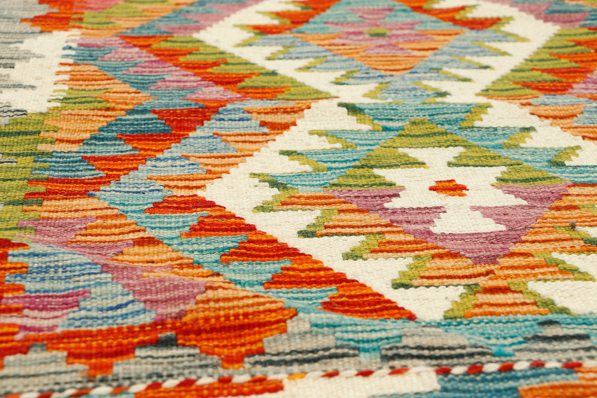 Afghan Kilim runner rug by eastofhere, 152x61cm, featuring traditional geometric patterns and vibrant earthy colors.