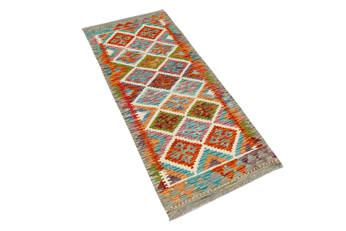 Afghan Kilim runner rug by eastofhere, 140x60cm, featuring traditional geometric patterns in vibrant colors.