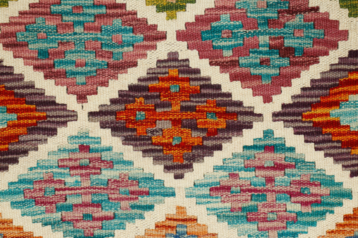 Afghan Kilim rug runner by eastofhere, 140x60cm, featuring traditional geometric patterns in vibrant colors and woven textile.