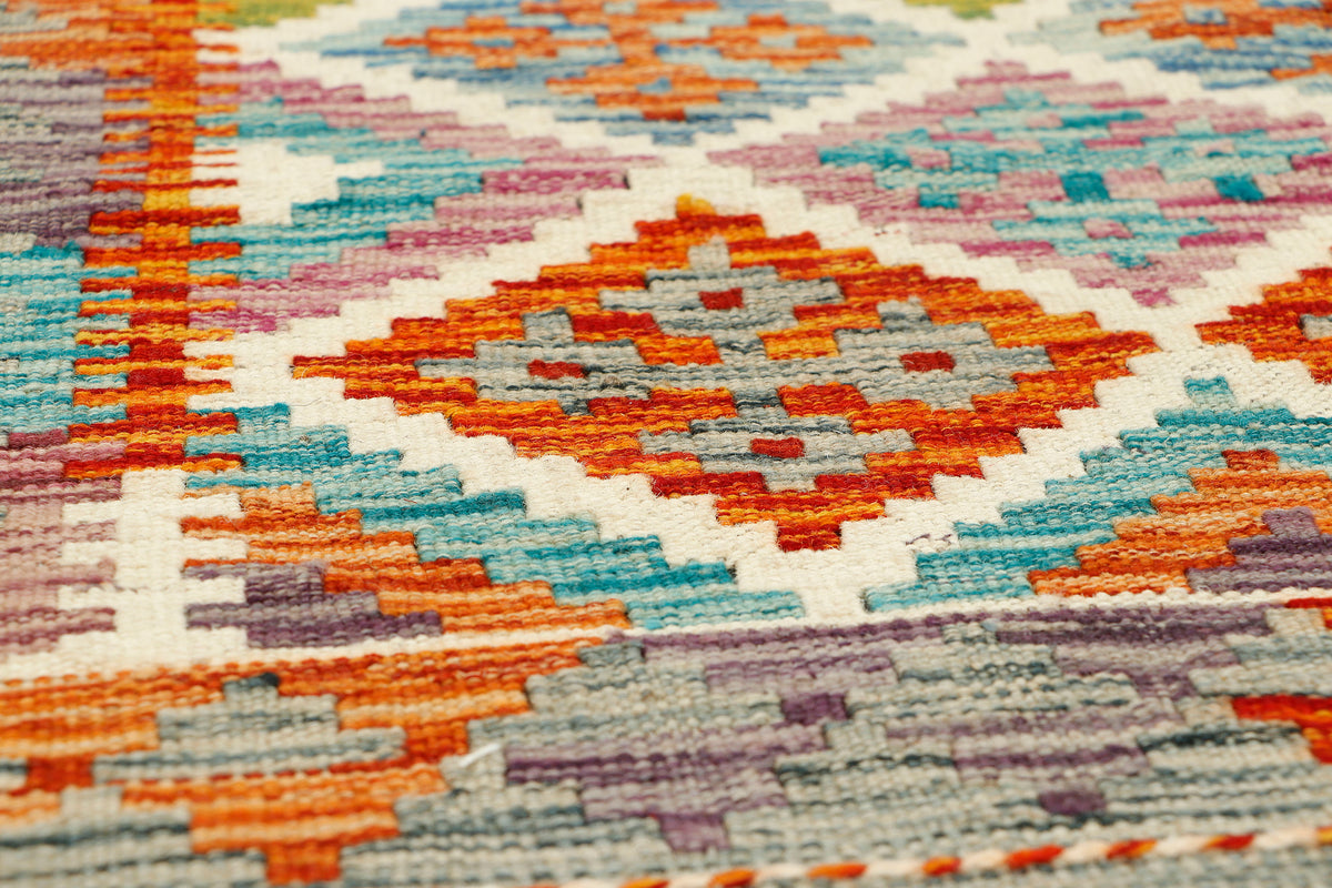 Afghan Kilim runner rug by eastofhere, 140x60cm, featuring traditional geometric patterns in vibrant colors on a woven textile background.