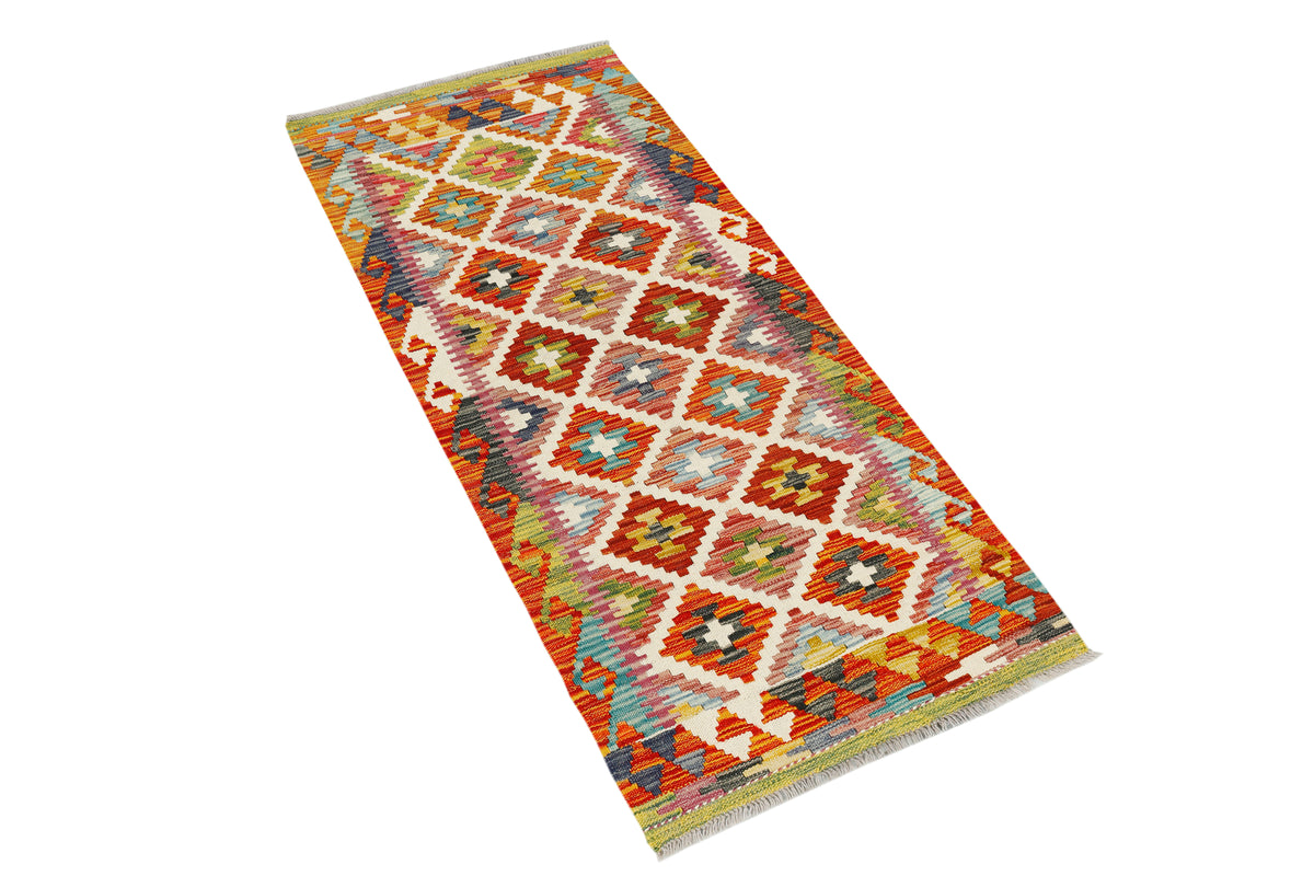 Afghan Kilim runner rug by eastofhere with geometric patterns in vibrant colors, measuring 150x64cm, laid out on a wooden floor.