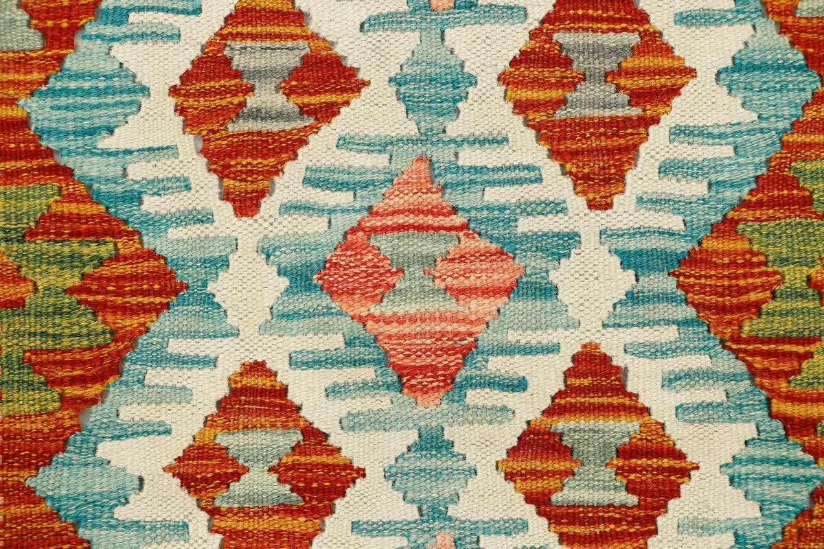 Afghan Kilim rug runner by eastofhere, 133x63cm, featuring traditional geometric patterns and vibrant earthy colors.