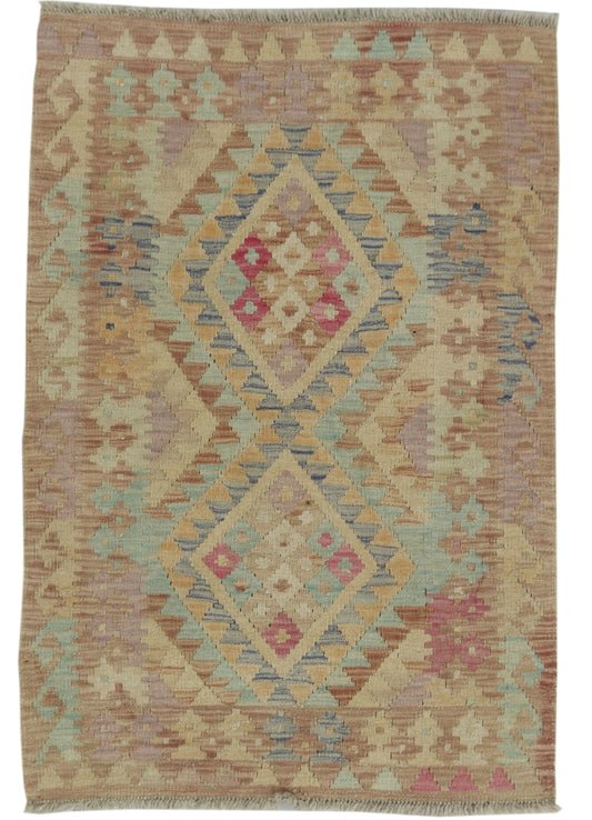 Afghan Kilim rug by East of Here, 113x77cm, featuring traditional geometric patterns in vibrant colors, laid flat on a wooden floor.