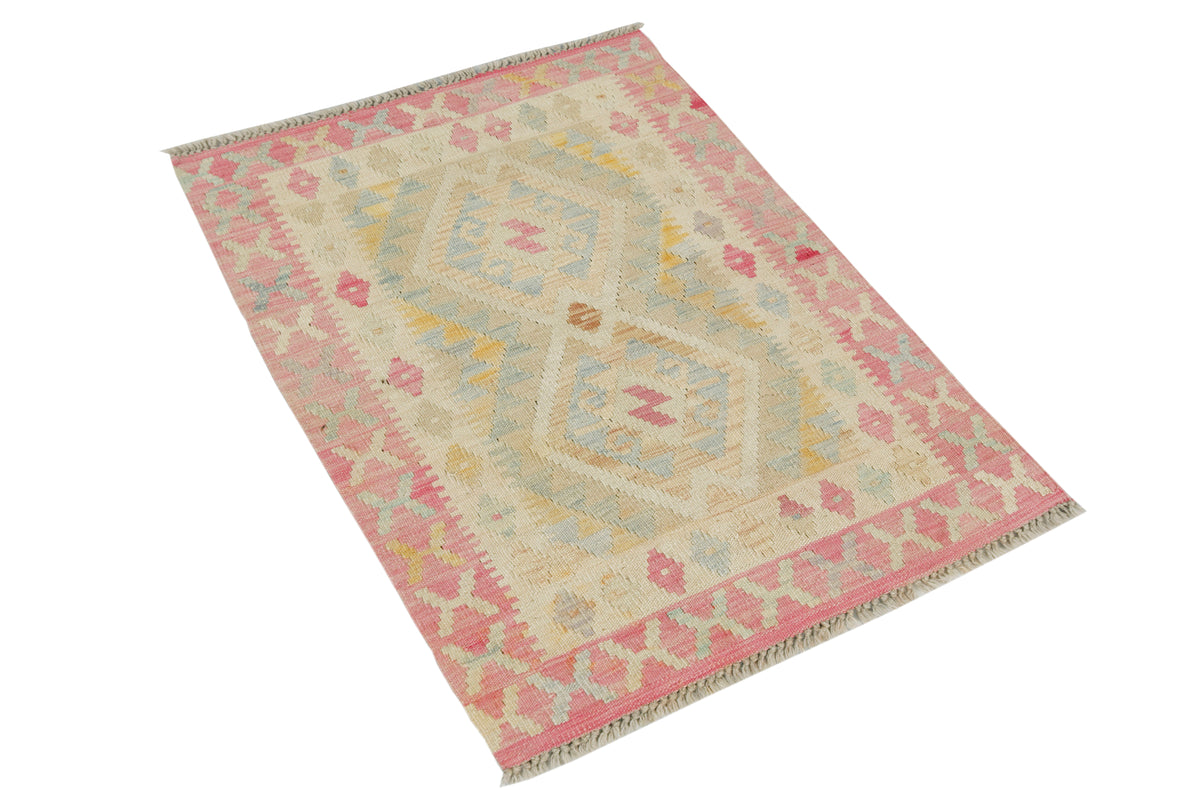 A rectangular kilim area rug with a cream base and a geometric diamond pattern in dusty pink, light blue, and soft yellow, shown on a plain white background.