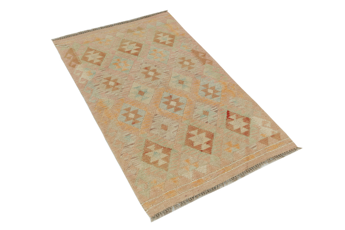 A rectangular woven area rug with a geometric diamond pattern in muted beige, tan, light blue, and terracotta tones, shown on a plain white background.