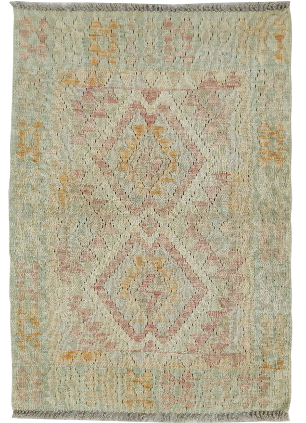 A flatweave kilim rug with a geometric diamond pattern in muted shades of dusty pink, ochre orange, and sage green on a cream and gray base.