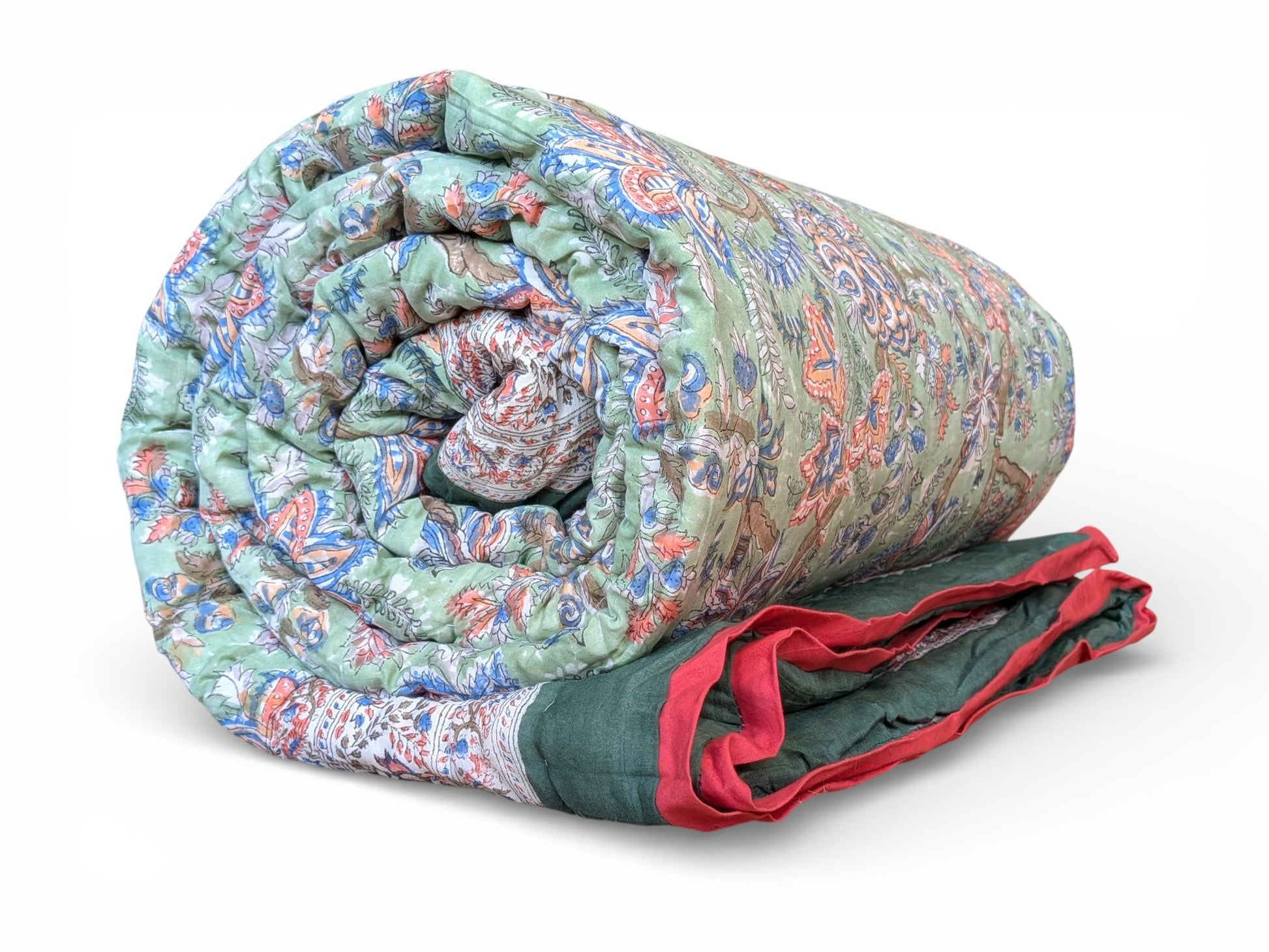 Rolled-up quilt with a colorful pattern on a white background