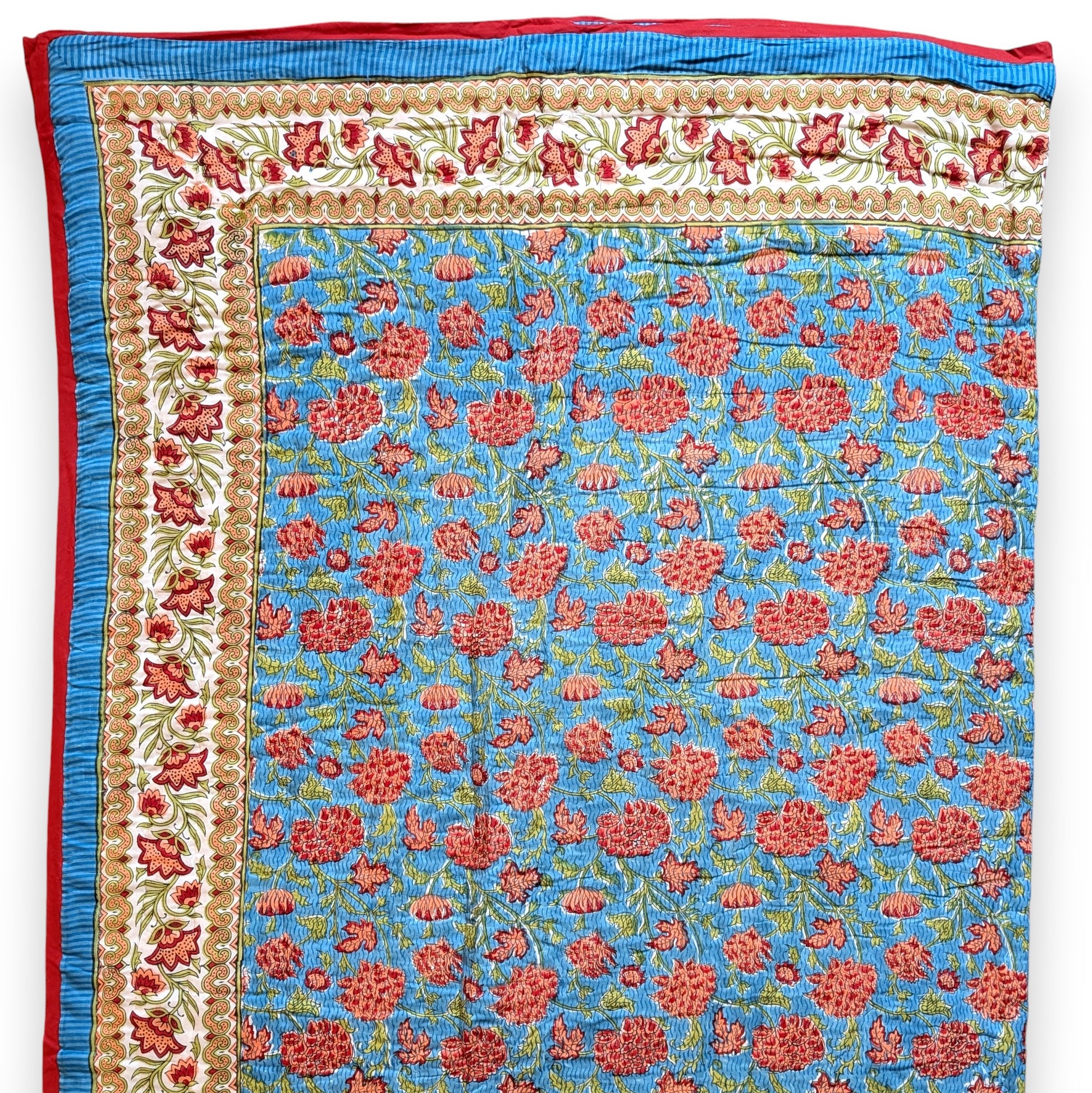 Floral patterned fabric with red flowers on a blue background