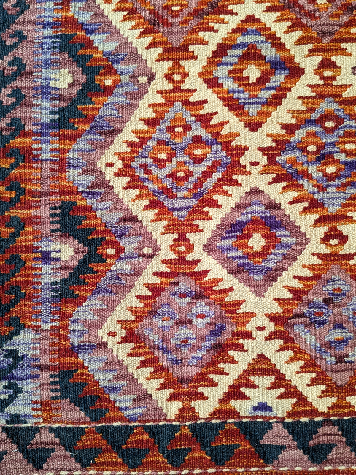 Eastofhere Kilim runner rug in vibrant geometric patterns, measuring 207x75cm, displayed on a wooden floor.