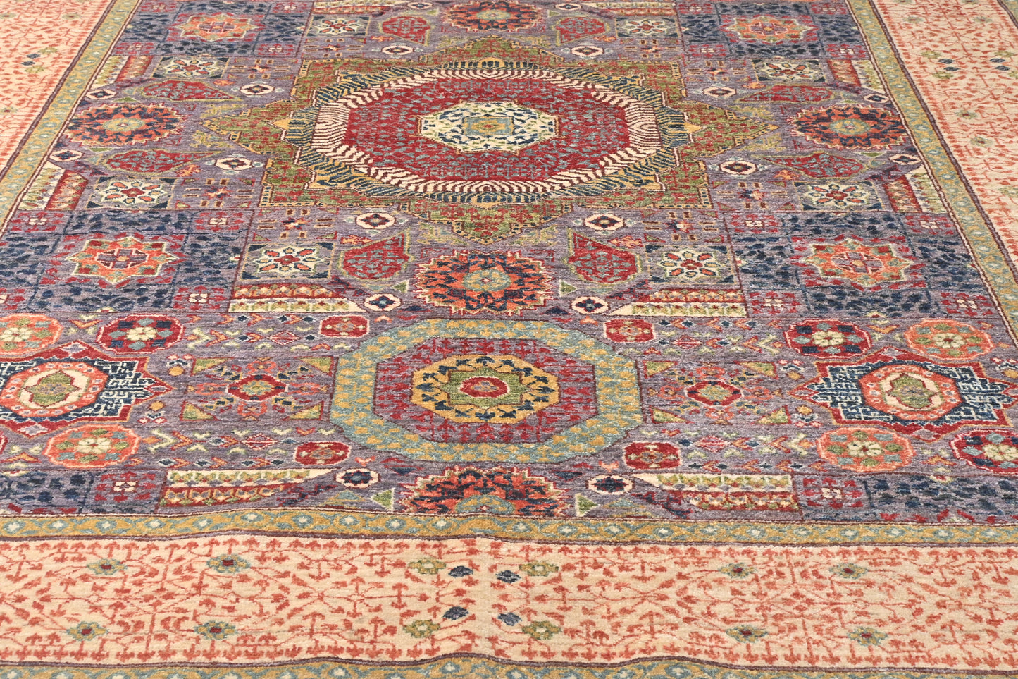 Close-up of a patterned rug with intricate designs.