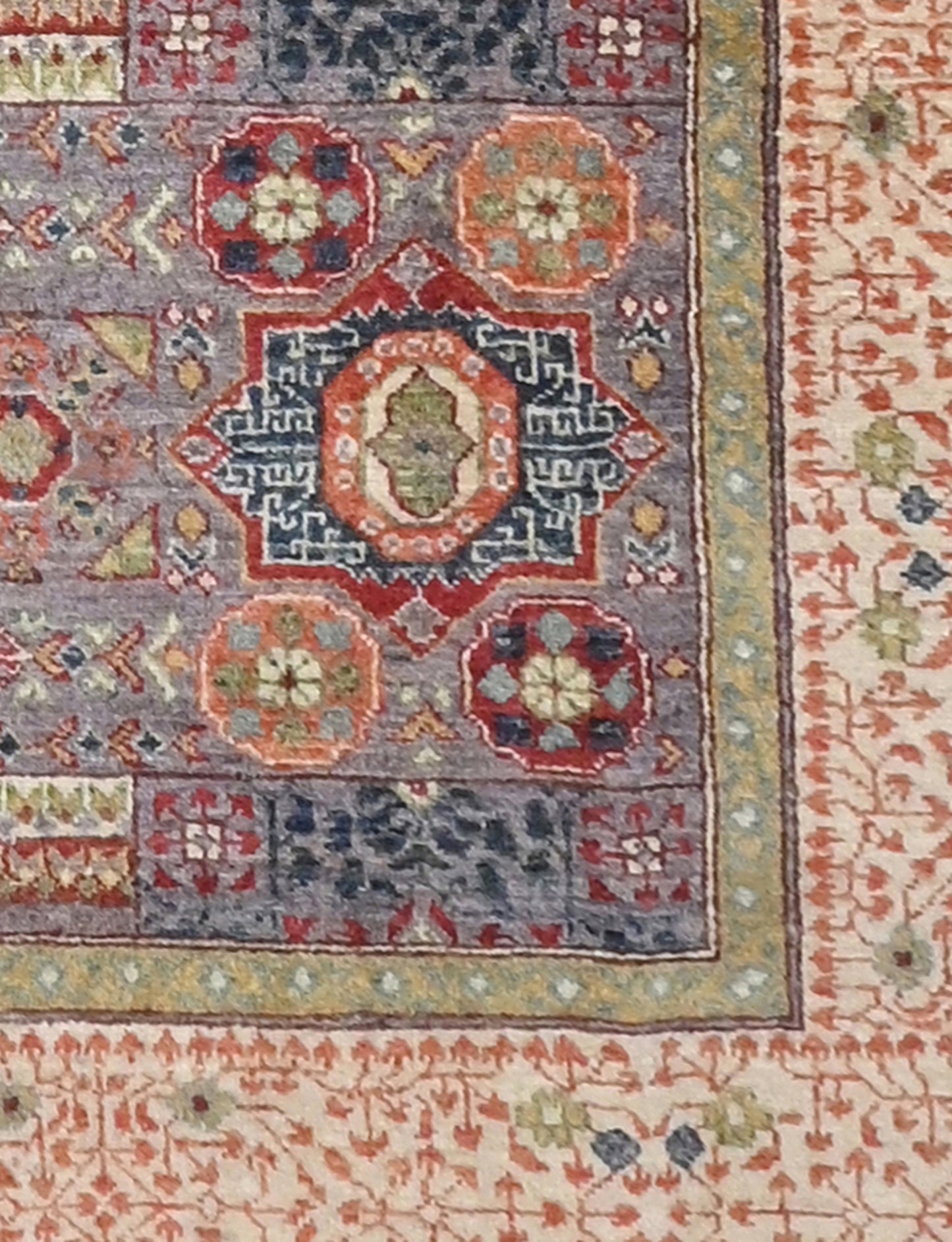 Close-up of a patterned rug with intricate designs in various colors.