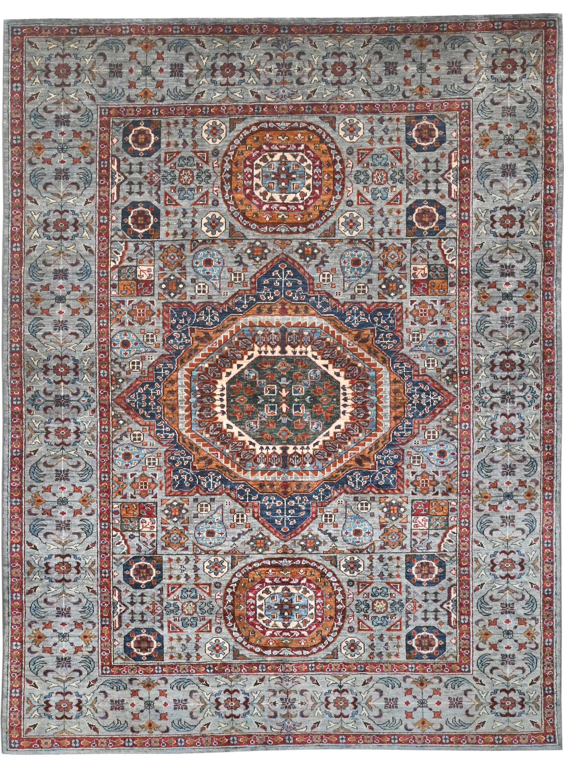 Decorative rug with intricate patterns and colors on a plain background