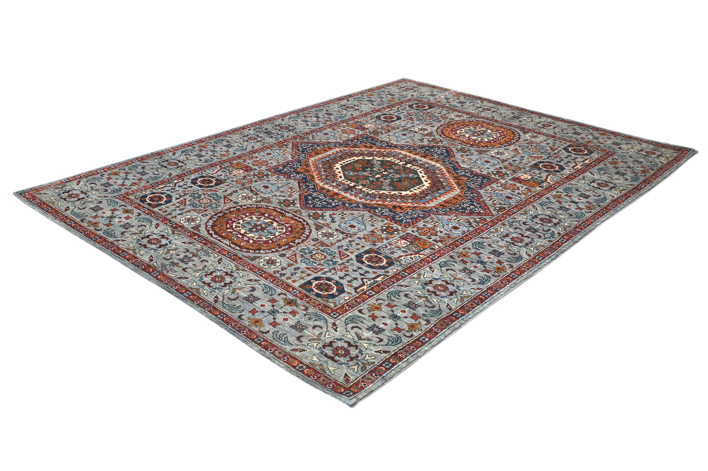 Decorative rug with intricate patterns on a white background