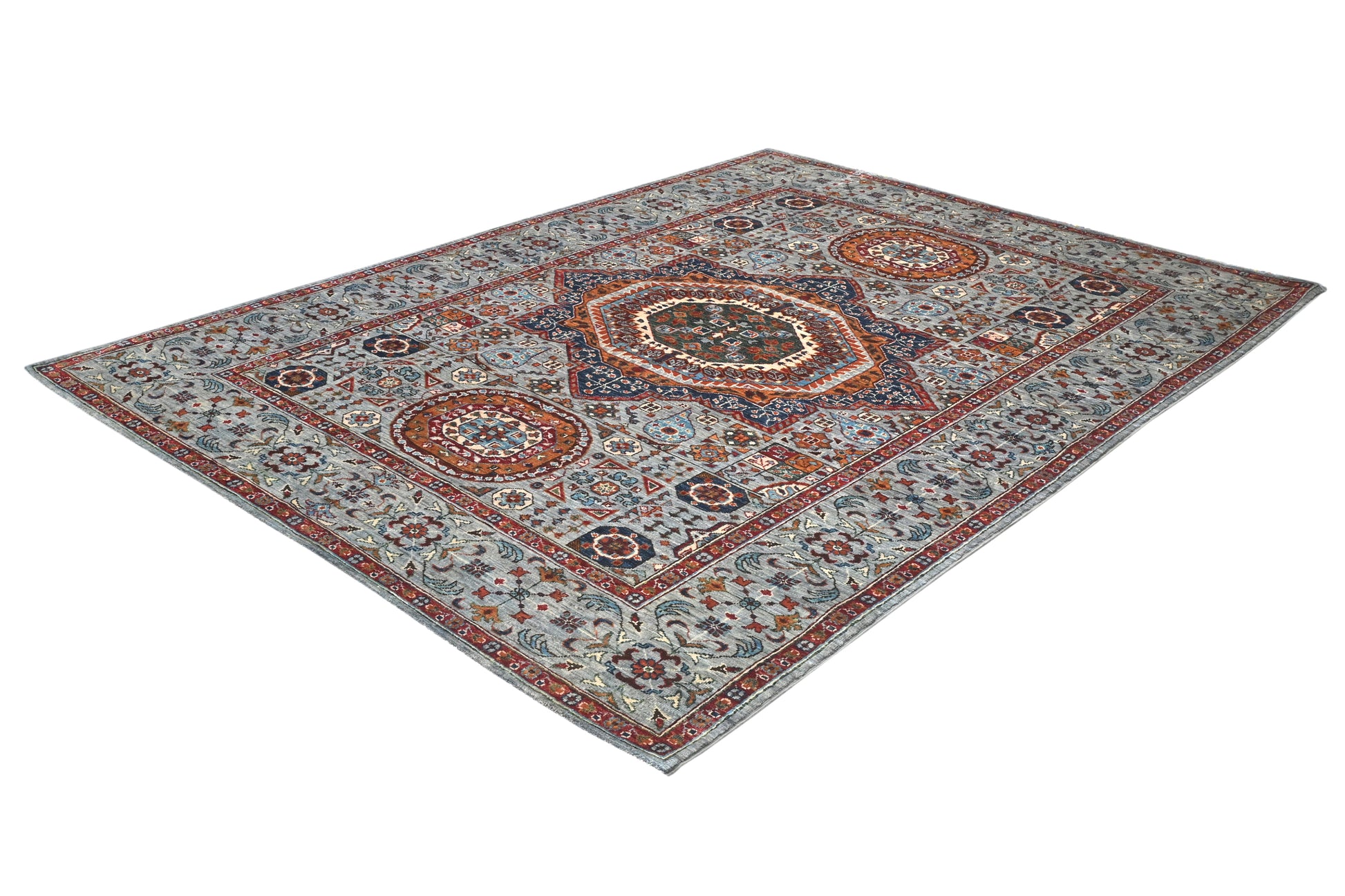 Decorative rug with intricate patterns on a white background