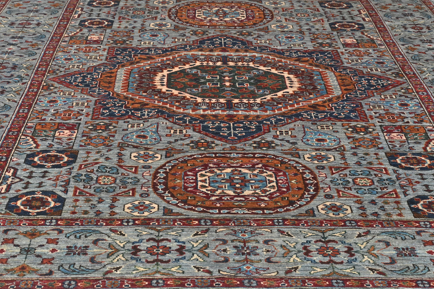 Close-up of a patterned rug with intricate designs.