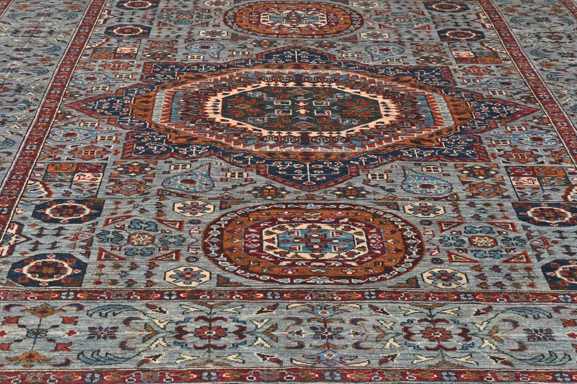 Close-up of a patterned rug with intricate designs.