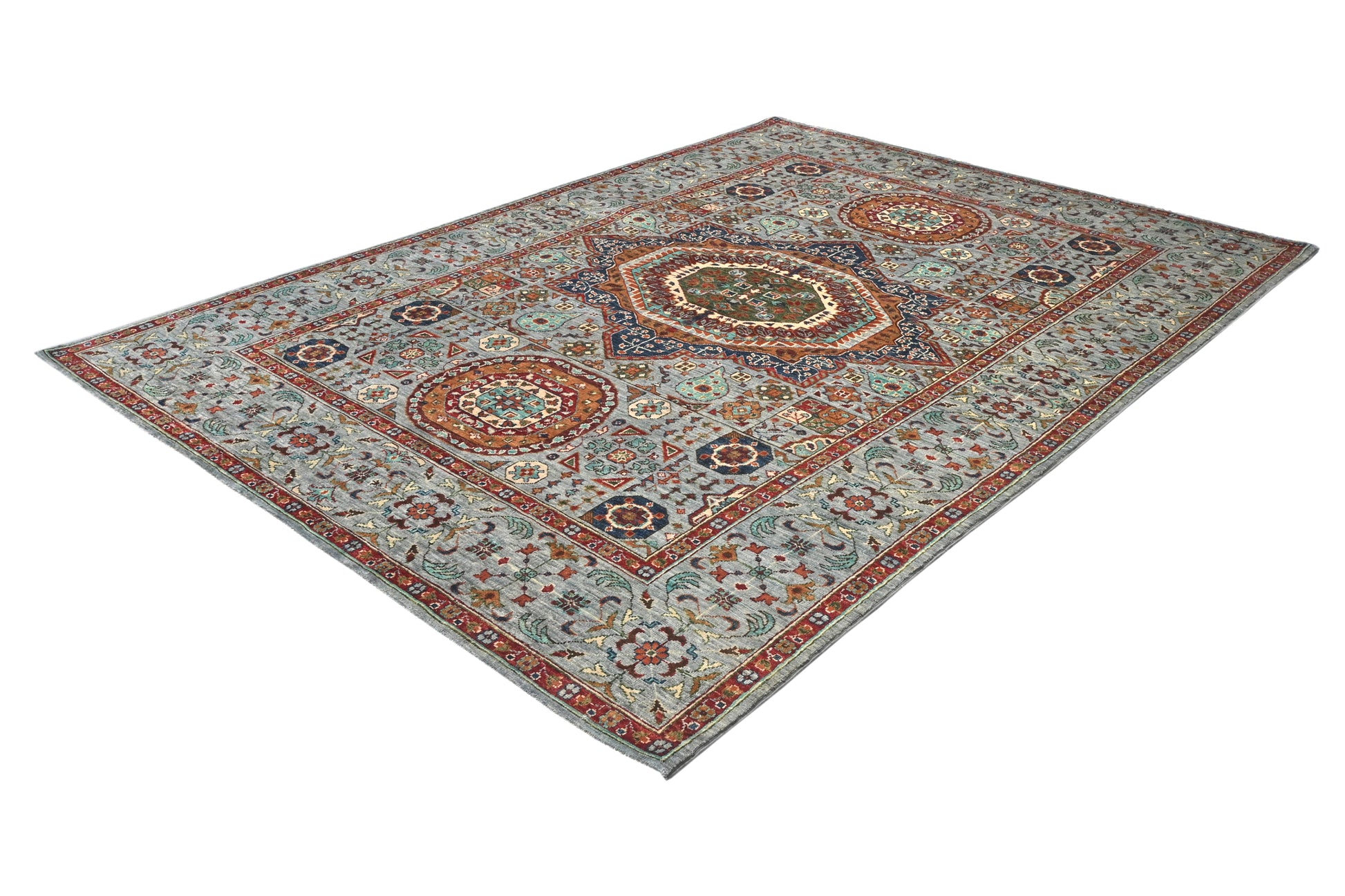 Decorative rug with intricate patterns on a white background