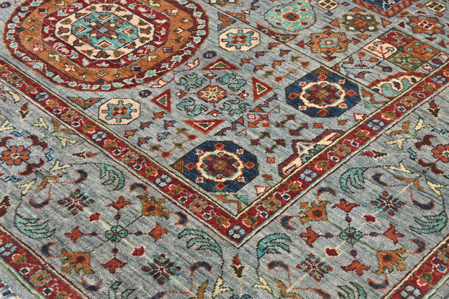 Close-up of a patterned rug with geometric designs in various colors.