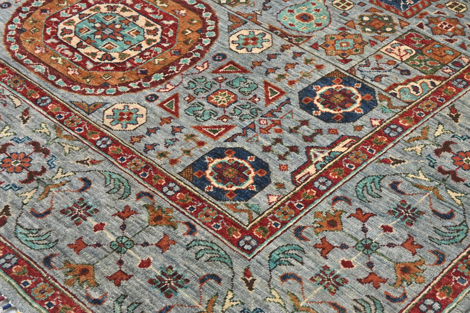 Close-up of a patterned rug with geometric designs in various colors.