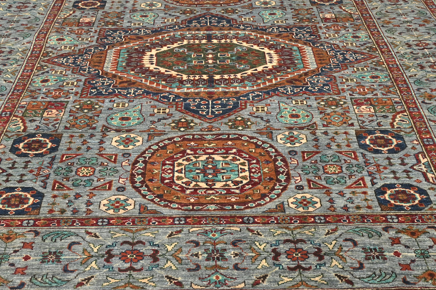 Close-up of a patterned rug with intricate designs.