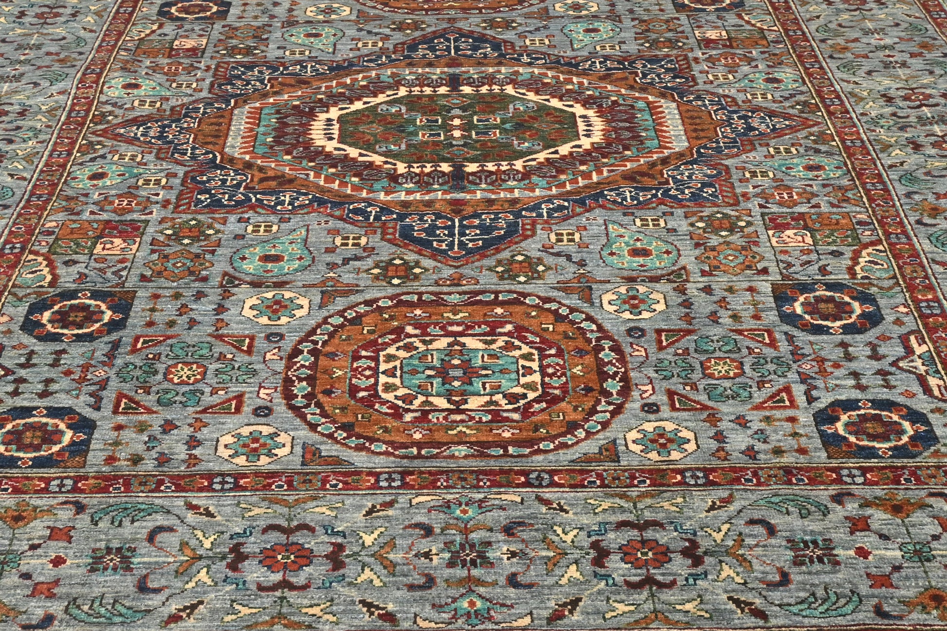 Close-up of a patterned rug with intricate designs.